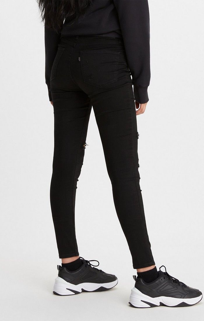 Women's Levi's 721 black jeans with holes